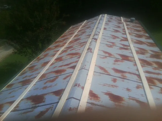 Rusted metal roof panels with new wood purlins before replacement — Storm Damage Roof Repair in Donald by Roofing Brothers